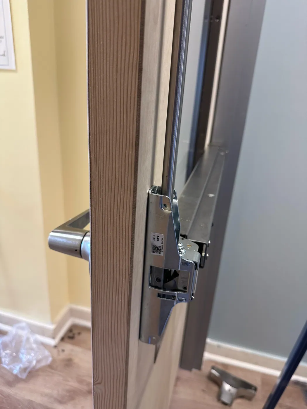Electric strike fitted to a commercial door frame