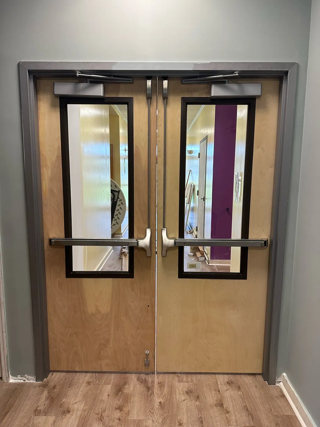 Double doors fitted with panic bars and closers