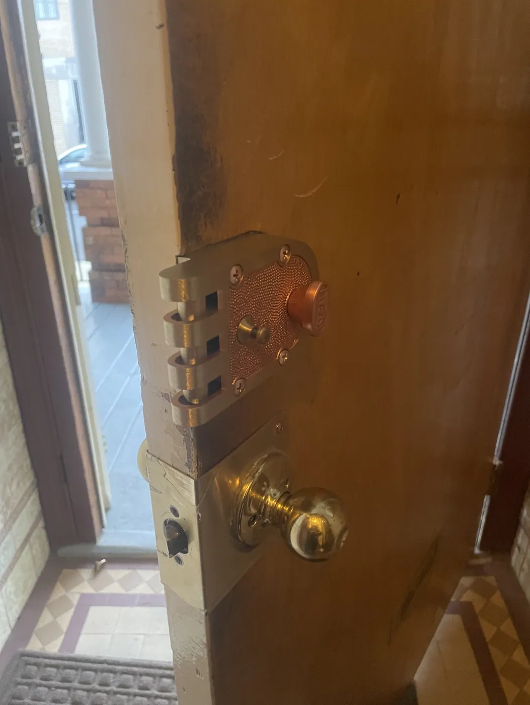 Jimmy-proof deadbolt installed on an apartment door